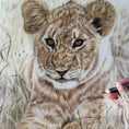 Load image into Gallery viewer, Artist drawing a coloured pencil portrait of a lion cub in the grass by Pets by Mills