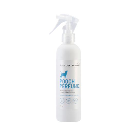 white dog perfume spray bottle with blue writing 