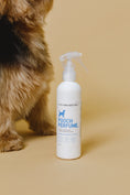 Load image into Gallery viewer, dog perfume bottle on range backdrop with a fluffy dog 
