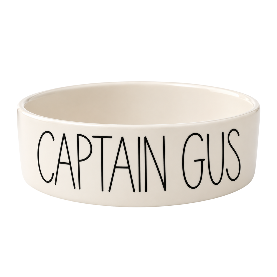Personalised cream ceramic dog bowl hand painted with the name CAPTAIN GUS