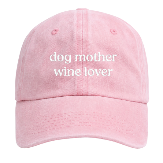 Pink cap with 'dog mother wine lover' text on a white background